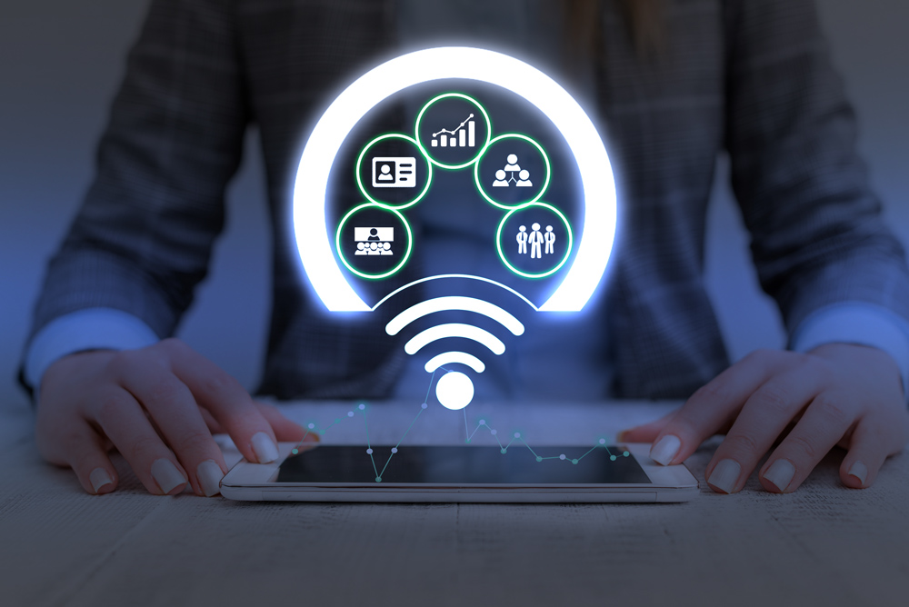 woman looking at tablet with network graphic